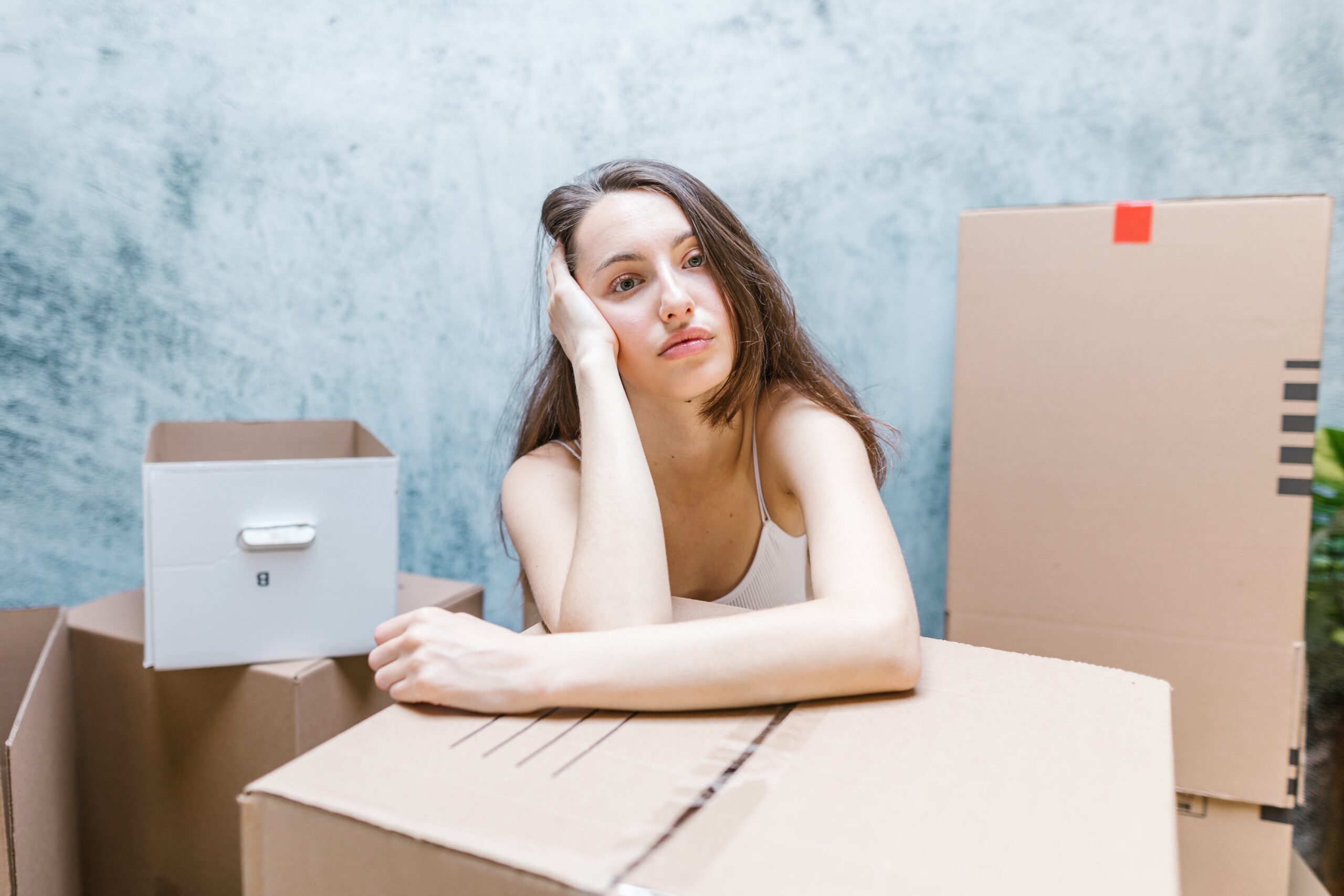 Interstate Removalist Backloading - Woman standing amidst boxes